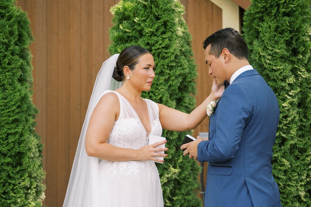 BRIDE AND GROOM READING PRIVATE VOWS