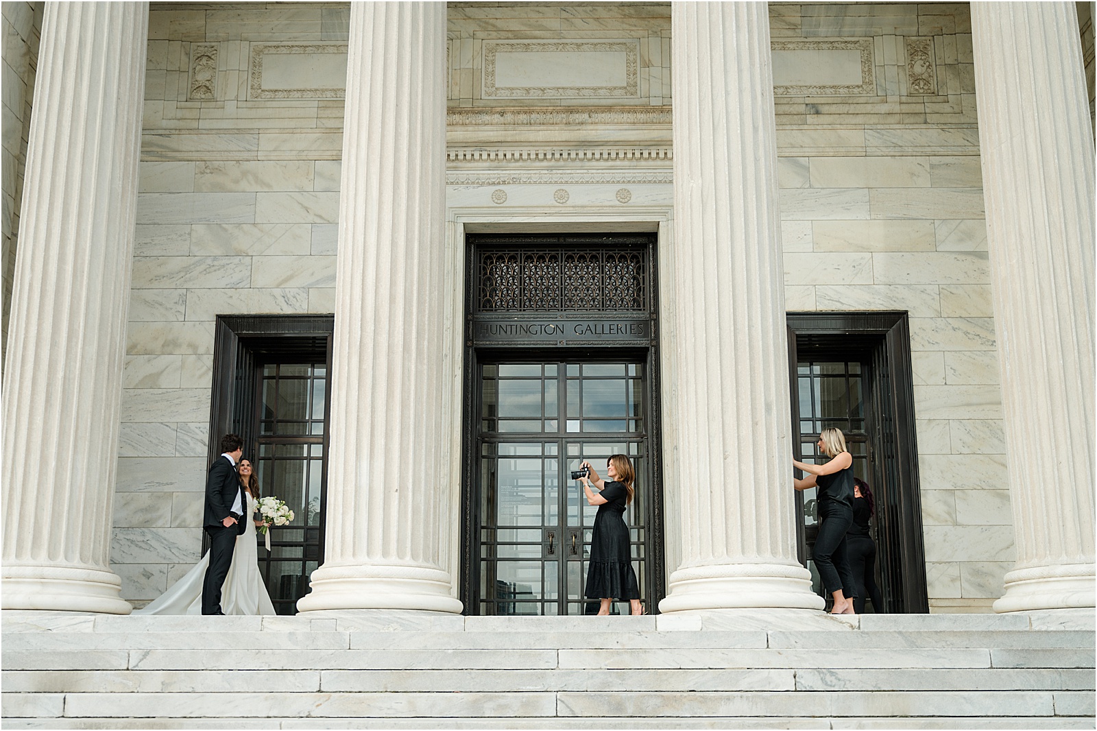 Behind the scenes of a wedding photo shoot at the Cleveland Museum of Art, featuring a couple sharing a quiet moment as the photographer captures the perfect shot.